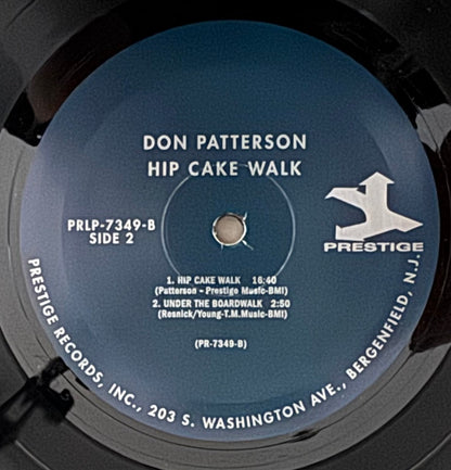 Vinyl record with a blue label featuring 'Don Patterson Hip Cake Walk' on a black background.