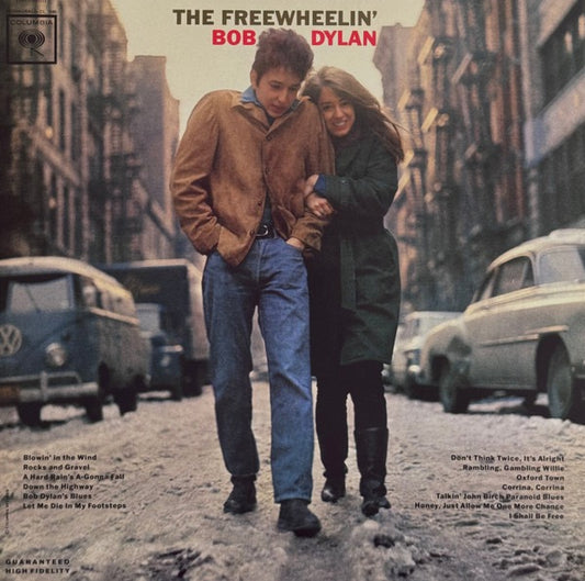 The Freewheeling' Bob Dylan Album cover with a couple walking on a street, surrounded by vintage cars.
